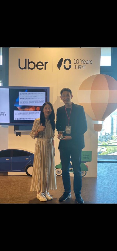 Eric holding an award at an Uber 10 Years event.